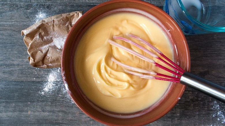 Bowl of pudding with whisk