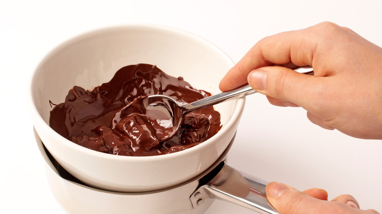 Stirring chocolate in white bowl