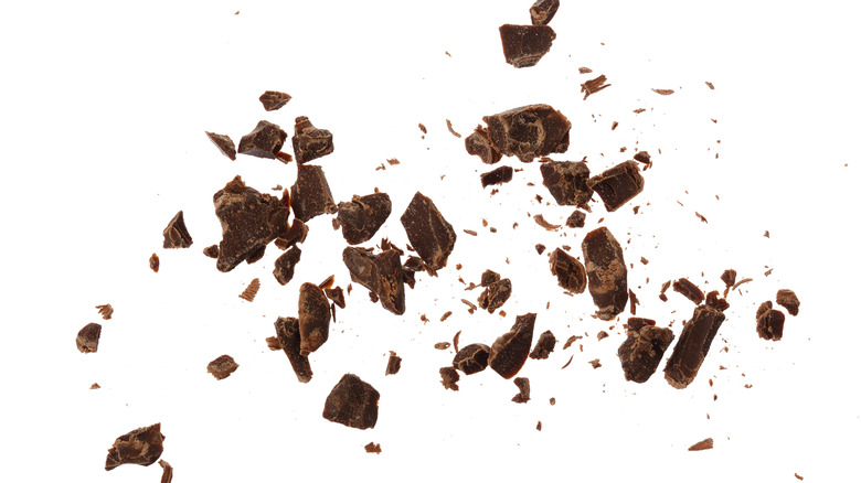 Grated chocolate on white background