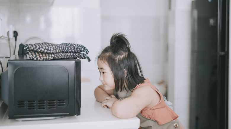 Child watching microwave 