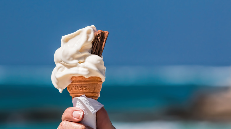 Melting ice cream cone blue background