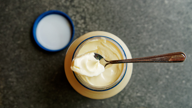 Spoonful of mayonnaise in jar 