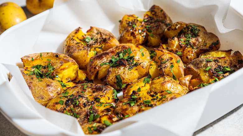 Smashed baked potatoes in dish