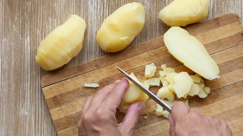 A person cutting potatoes