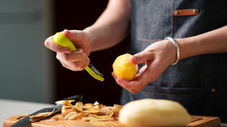 A person cutting potatoes