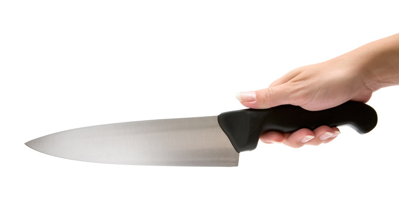 A person gripping a knife