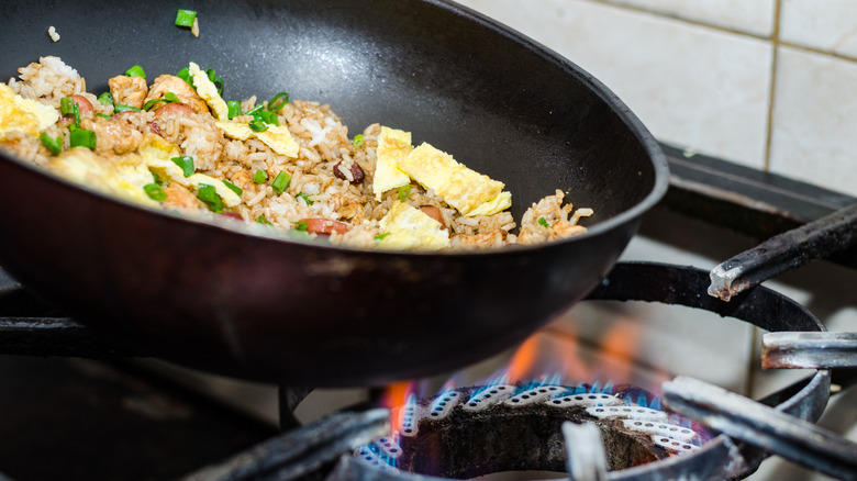 Eggs and rice frying in a pan