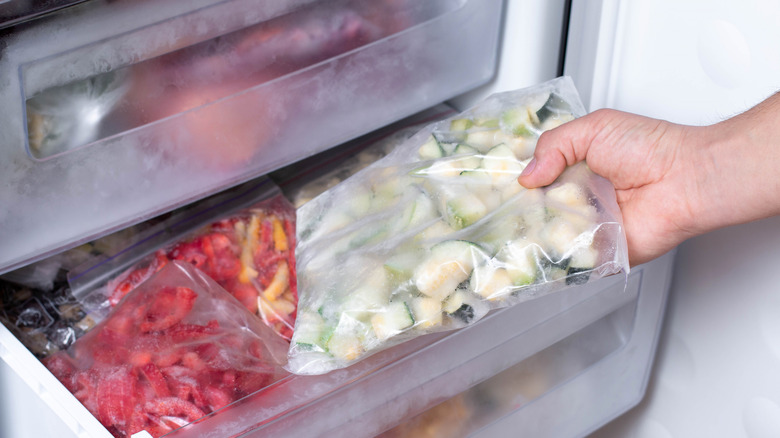 Putting bagged vegetables in freezer