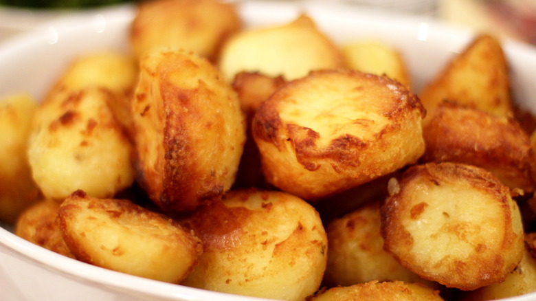 Roasted potatoes on white plate