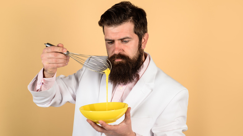 Person whisking eggs in bowl