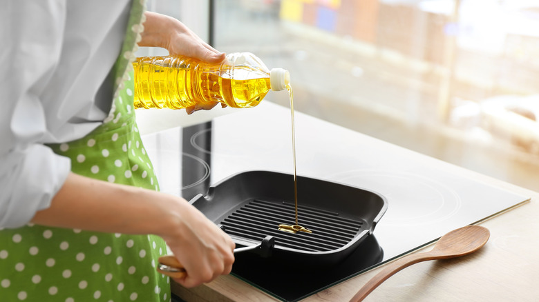 Pouring oil into skillet