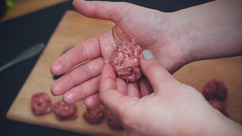 Person shaping meatballs