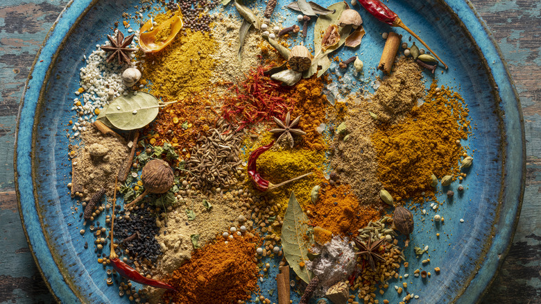 Vibrant spices on blue plate