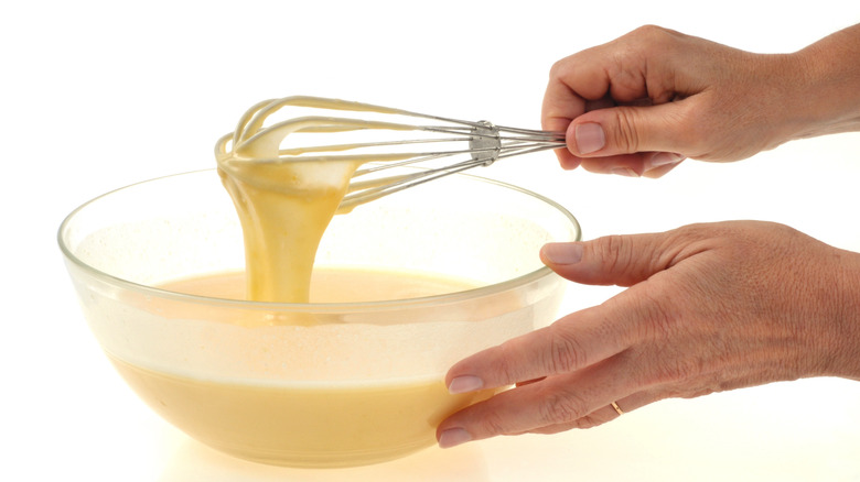 Whisking cake batter in bowl