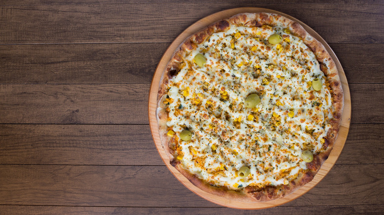 Pizza on table with cream