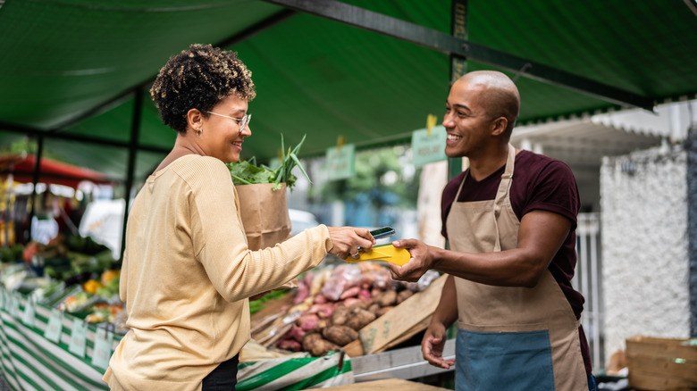 Making purchase at farmers' market