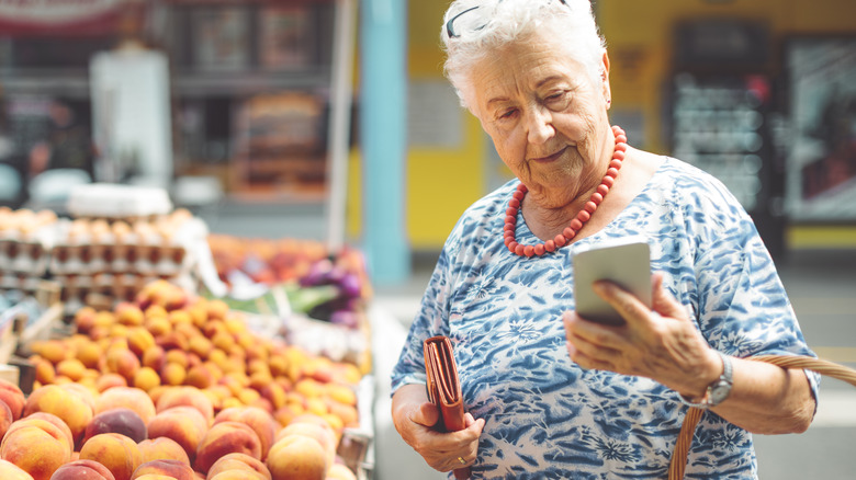 Person looking at phone at market