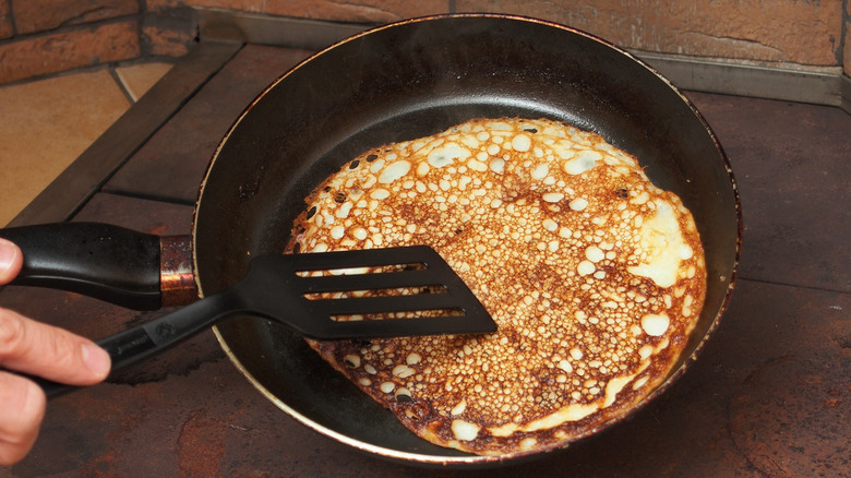 pressing pancake with spatula