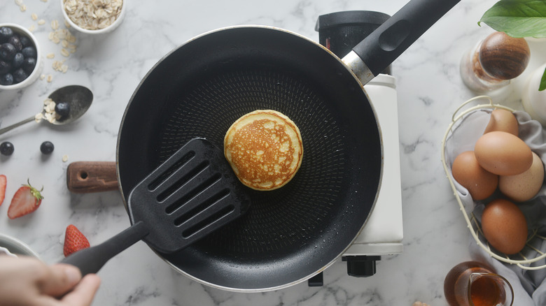 spatula flipping pancake on pan