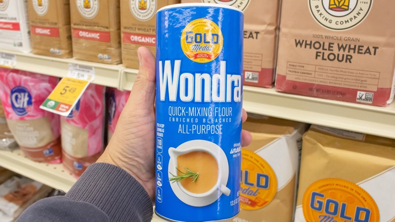 Hand holding Wondra flour can