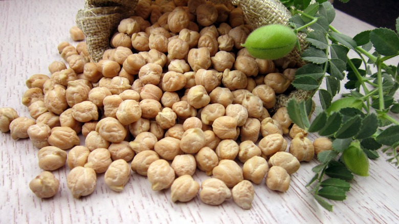 Uncooked chickpeas spilling from sack