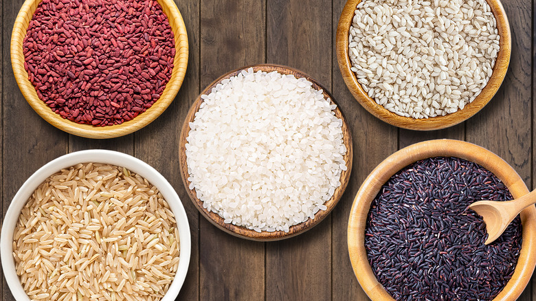 Multiple bowls containing different varieties of rice