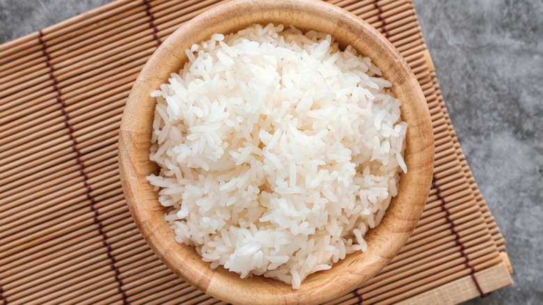 wooden bowl filled with cooked jasmine rice