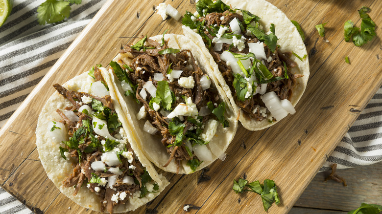 Barbacoa tacos with cilantro and onion