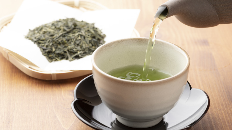 pouring warm green tea