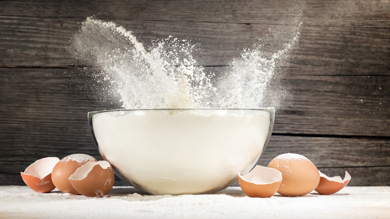 Flour splashing out of a bowl