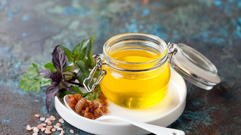 Duck fat in jar on table