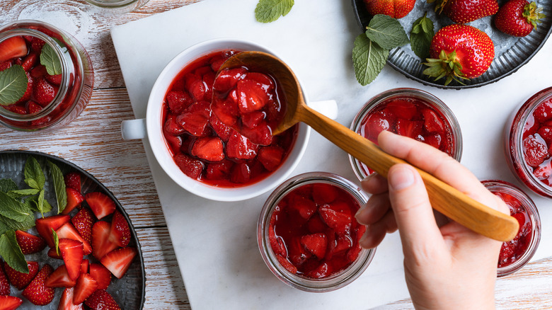 Strawberry compote in containers with whole fruit