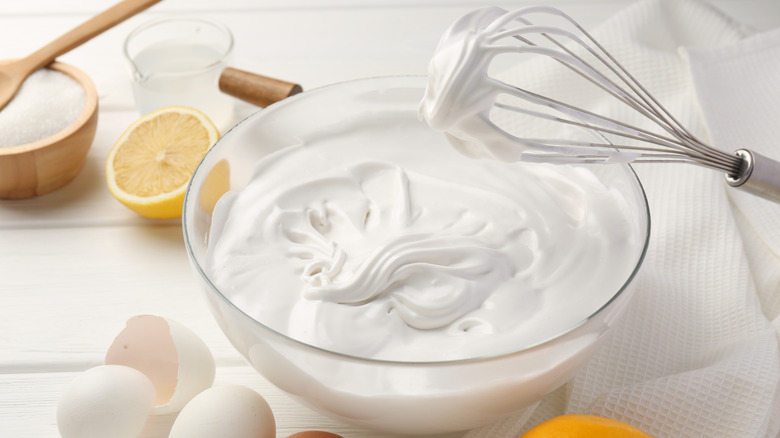 Bowl of whipped cream with eggs and lemon
