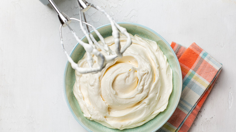 Bowl of whipped ricotta with beaters