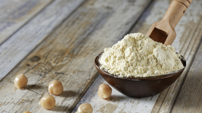 Bowl of chickpea flour with wooden scoop