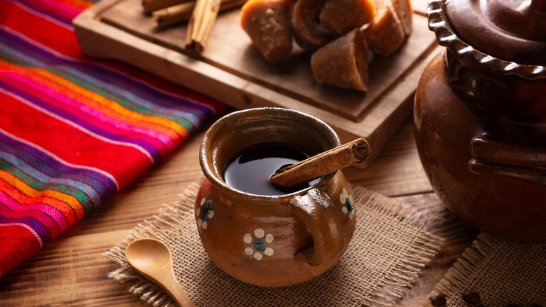 Preparing café de olla with different ingredients and colorful fabric