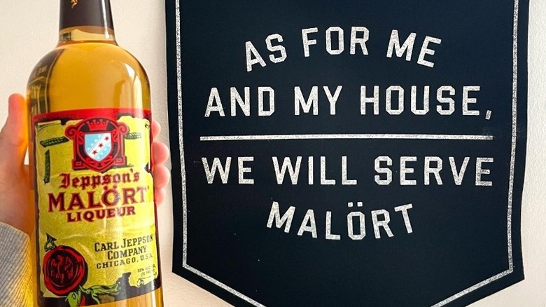 hand holding bottle of Malört