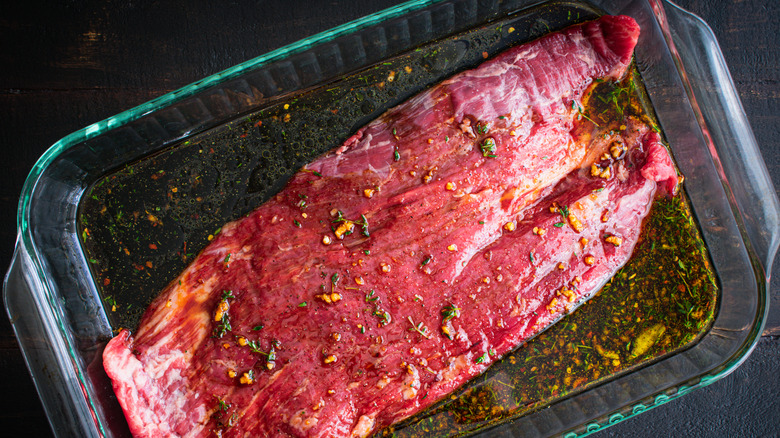 Steak marinating in tray