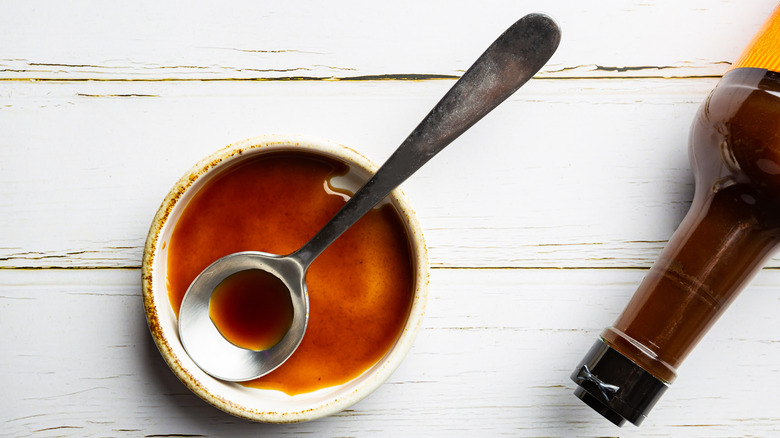 Worcestershire sauce, spoon in bowl