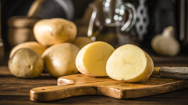 sliced potatoes on wood board