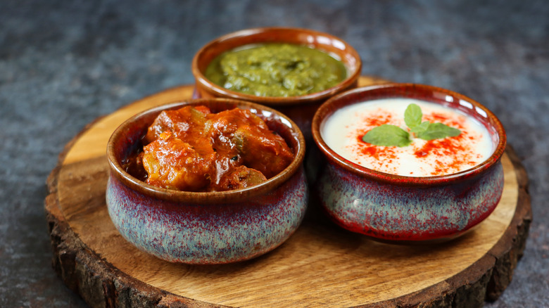 Three Indian condiments in bowls