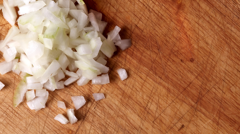 Diced raw onions on cutting board