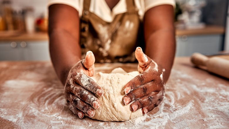 Baker shaping bread dough