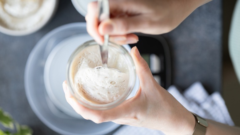 Woman holding sourdough starter