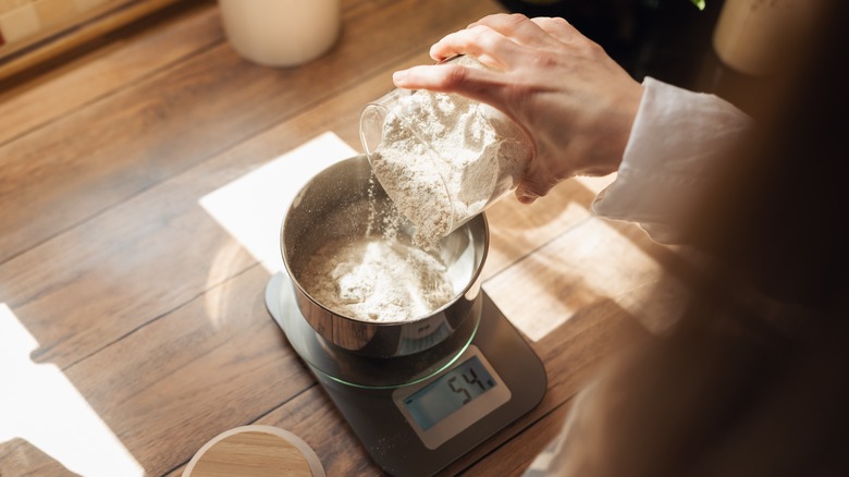 Woman weighing flour on a scale