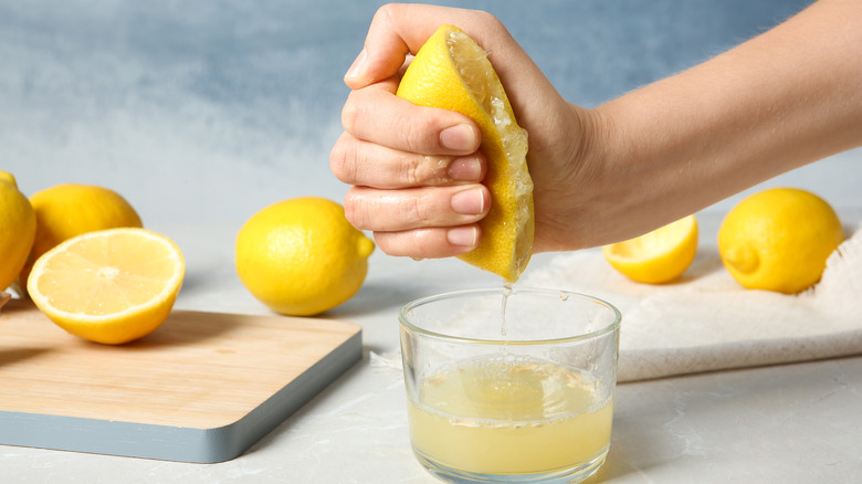 hand squeezing lemon juice