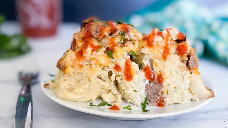 Breakfast casserole topped with hot sauce