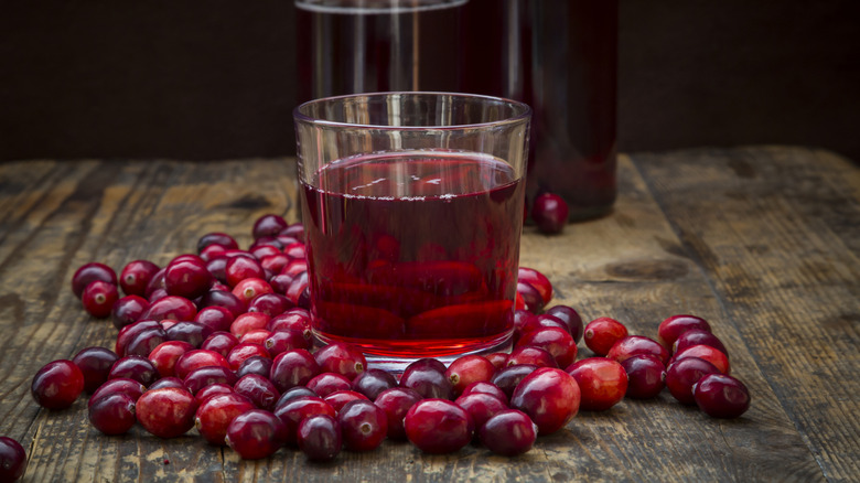 Cranberry juice in glass and fresh berries