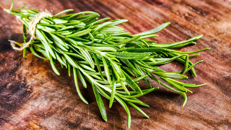 Fresh green rosemary on cutting board