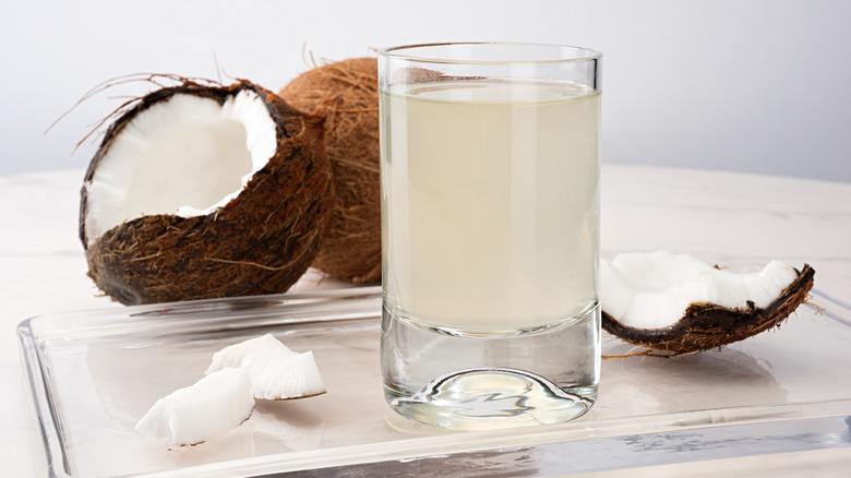 Fresh coconut water in a glass with coconut